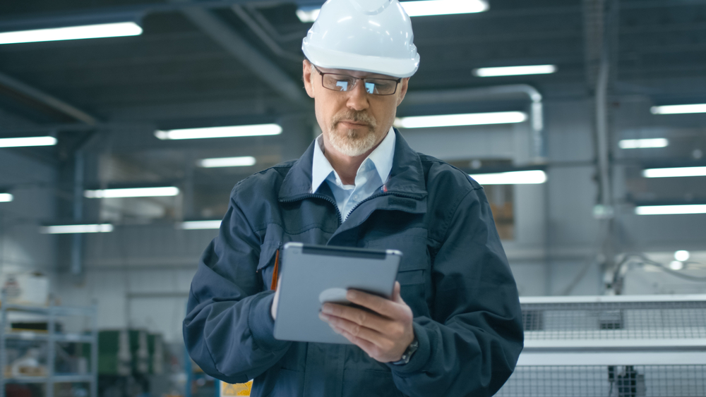 Factory worker on tablet